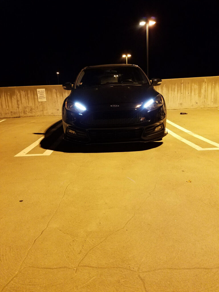 A nighttime photograph of a 2016 Ford Focus ST.