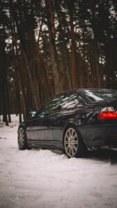 A gorgeous BMW E46 M3 parked in a winter wood.