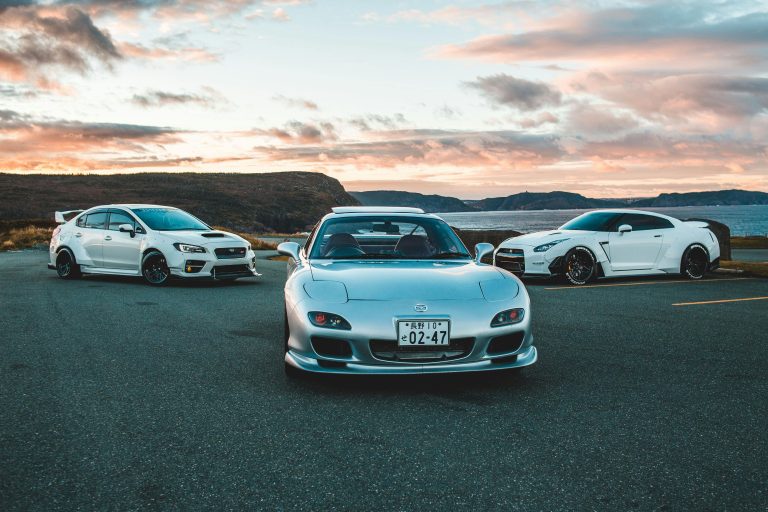 A Subaru WRX STi, A Nissan GT-R, and a Mazda RX-7 highlight iconic japanese cars that are skyrocketing in price.
